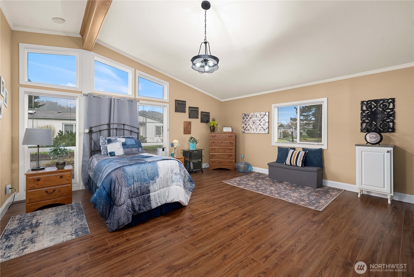 836 Harman Way South, Unit 62 Orting, WA 98360 - Photo 24 of 40 a spacious bedroom with a bed and wooden floor