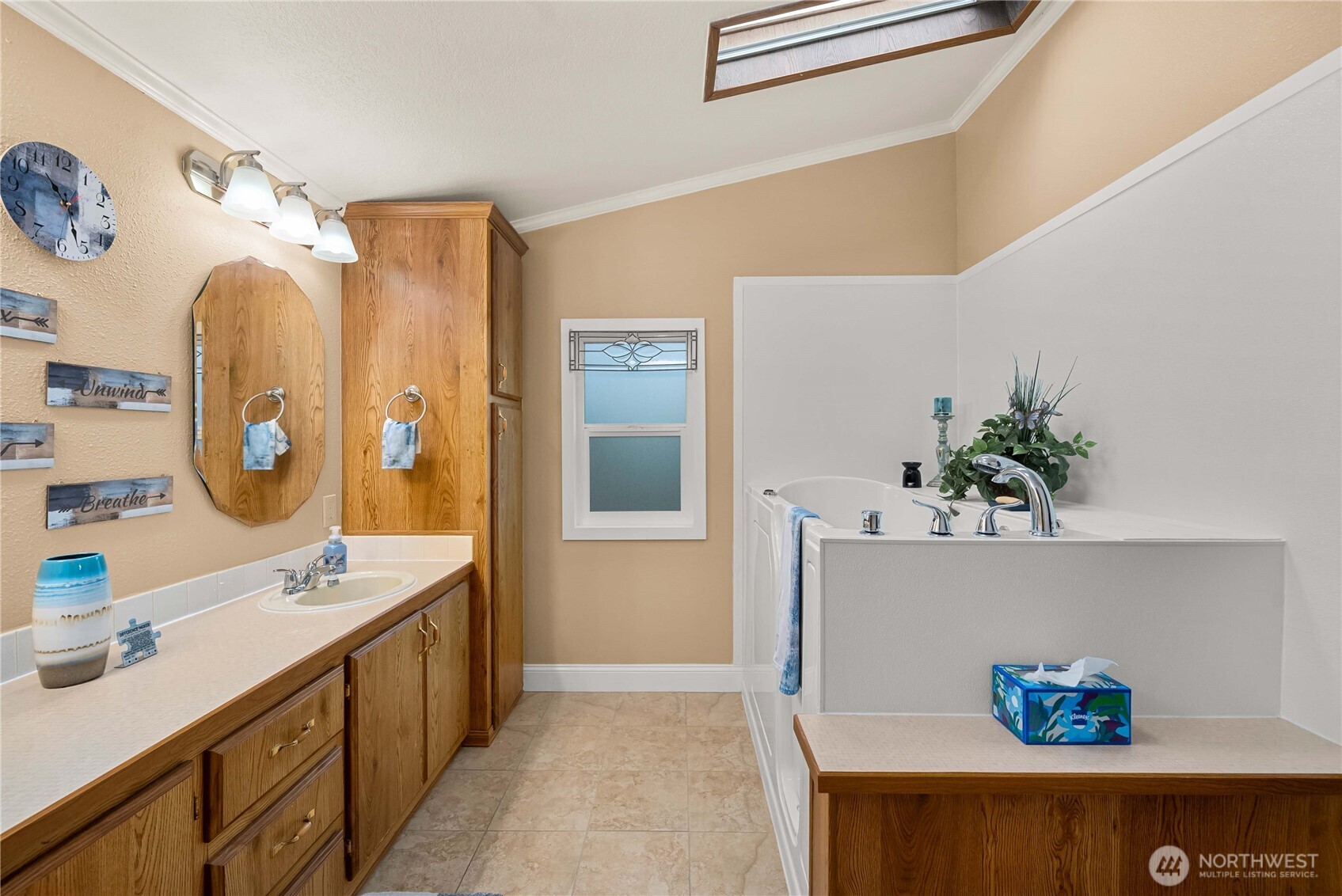 836 Harman Way South, Unit 62 Orting, WA 98360 - Photo 27 of 40 a spacious bathroom with a double vanity sink mirror and bathtub