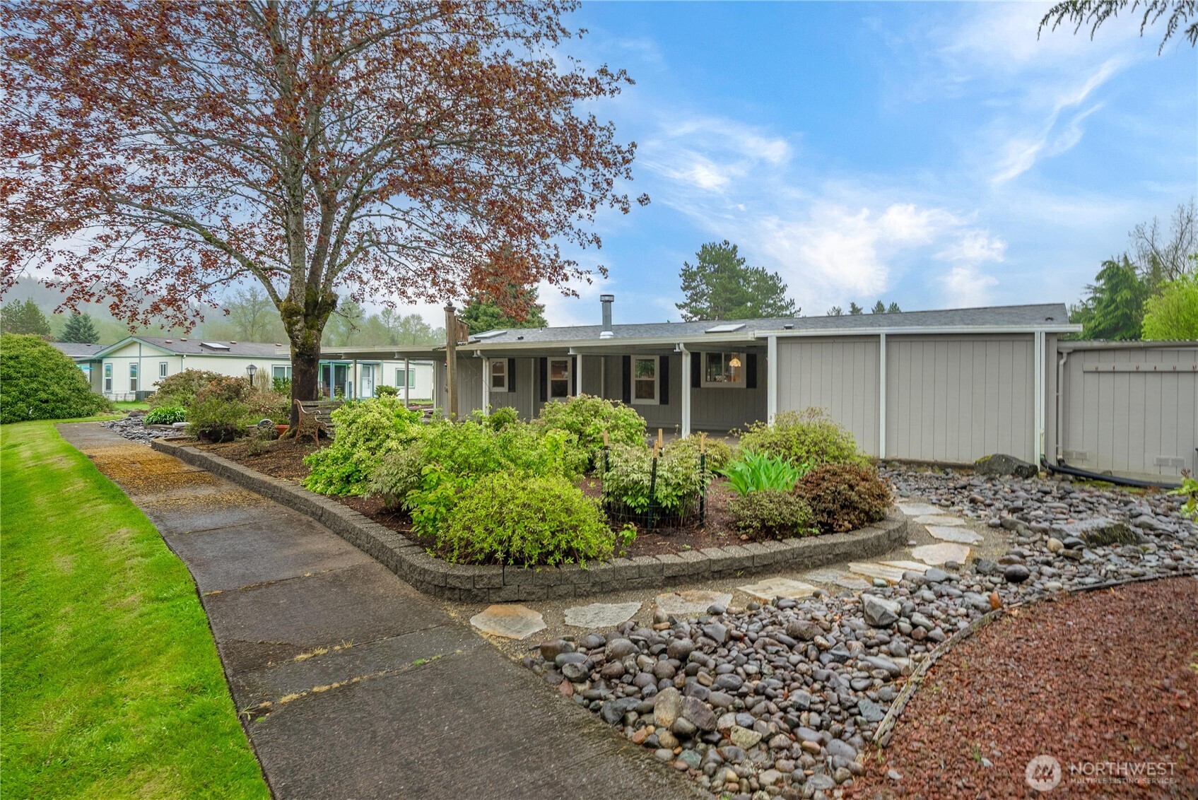 836 Harman Way South, Unit 62 Orting, WA 98360 - Photo 35 of 40 a front view of a house with garden