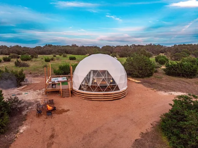 an aerial view of a house with outdoor space and a lake view in back