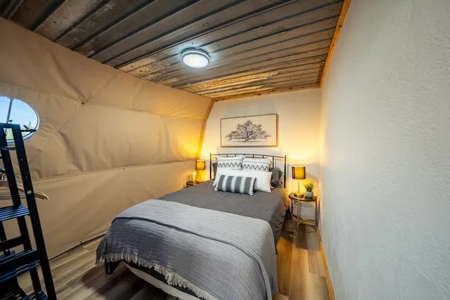 a bedroom with a bed and a mirror