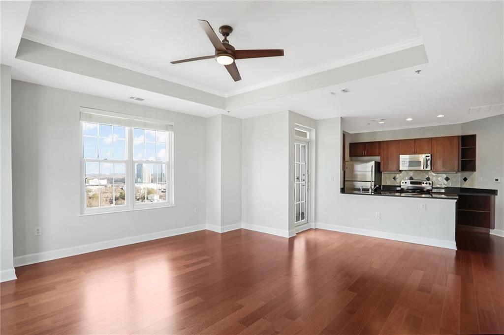 325 East Paces Ferry Road Northeast, Unit 2211 Atlanta, GA 30305 - Photo 1 of 1 a view of a living room a window and wooden floor
