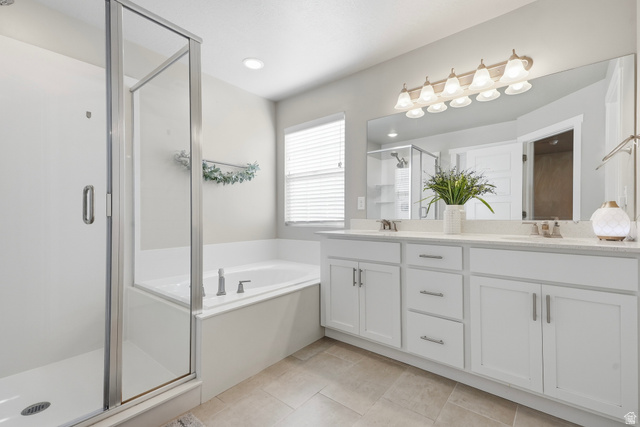 3244 West 1670th Street North Provo, UT 84601 - Photo 29 of 56 Bathroom featuring a glass-enclosed shower, built-in soaking tub, dual vanity with white cabinetry, and a large mirror with overhead lighting