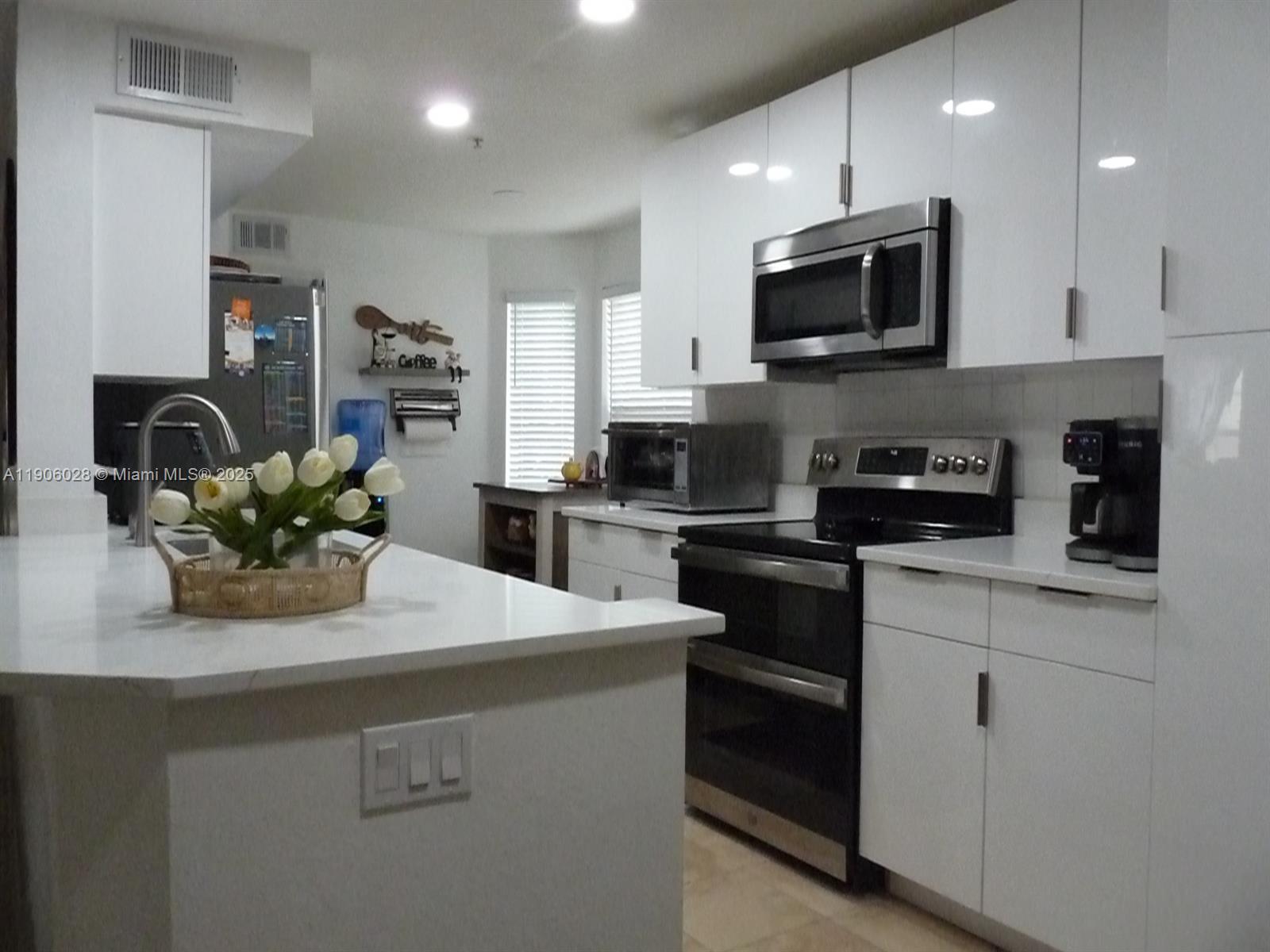 400 Summit Ridge Place, Unit 216 Longwood, FL 32779 - Photo 1 of 25 a kitchen with appliances a sink and cabinets