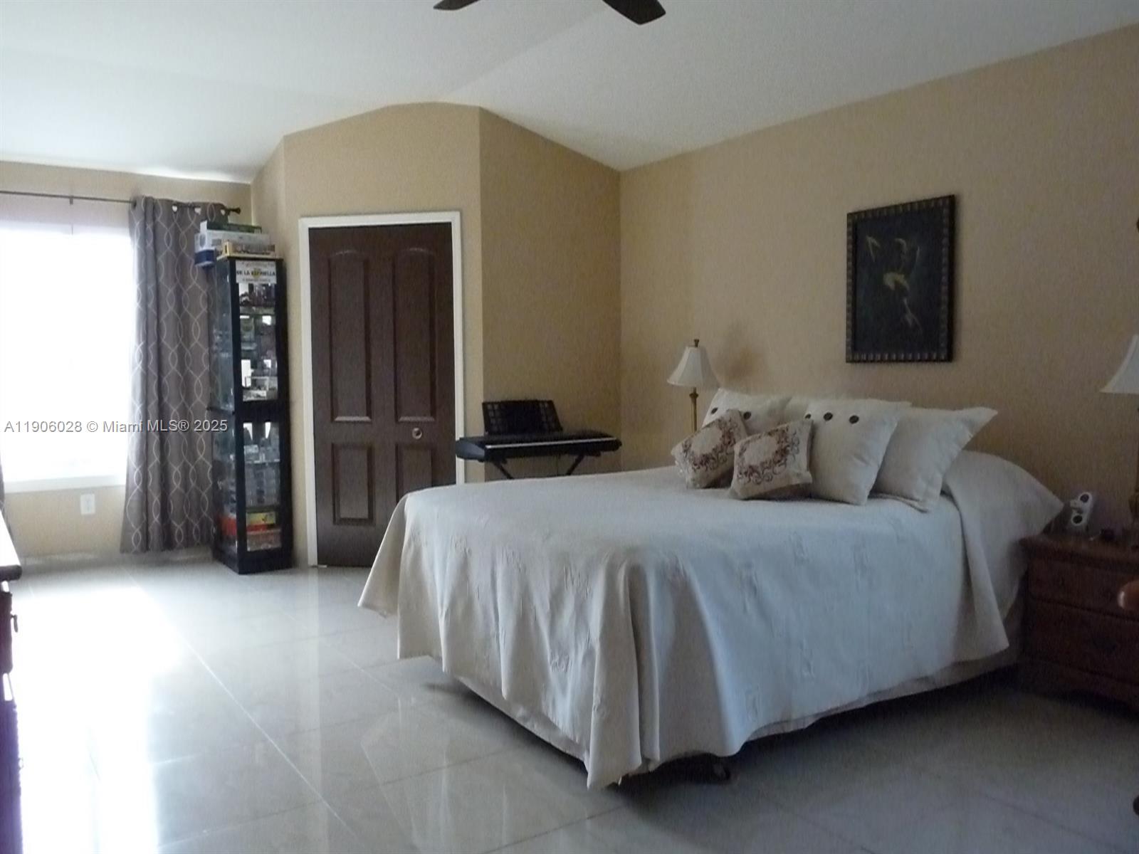 400 Summit Ridge Place, Unit 216 Longwood, FL 32779 - Photo 12 of 25 a bedroom with a bed and a lamp