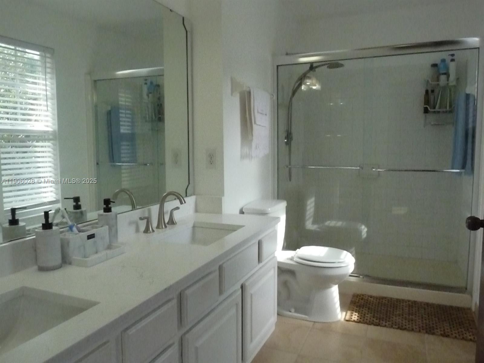 400 Summit Ridge Place, Unit 216 Longwood, FL 32779 - Photo 13 of 25 a bathroom with a sink a toilet and shower