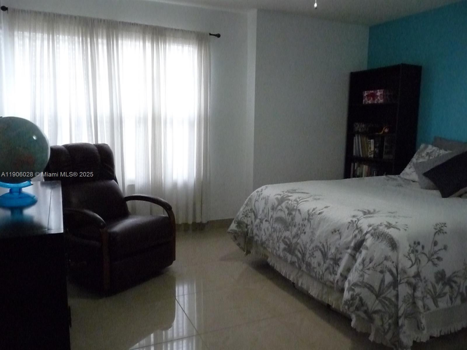 400 Summit Ridge Place, Unit 216 Longwood, FL 32779 - Photo 15 of 25 a bedroom with a bed and a couch