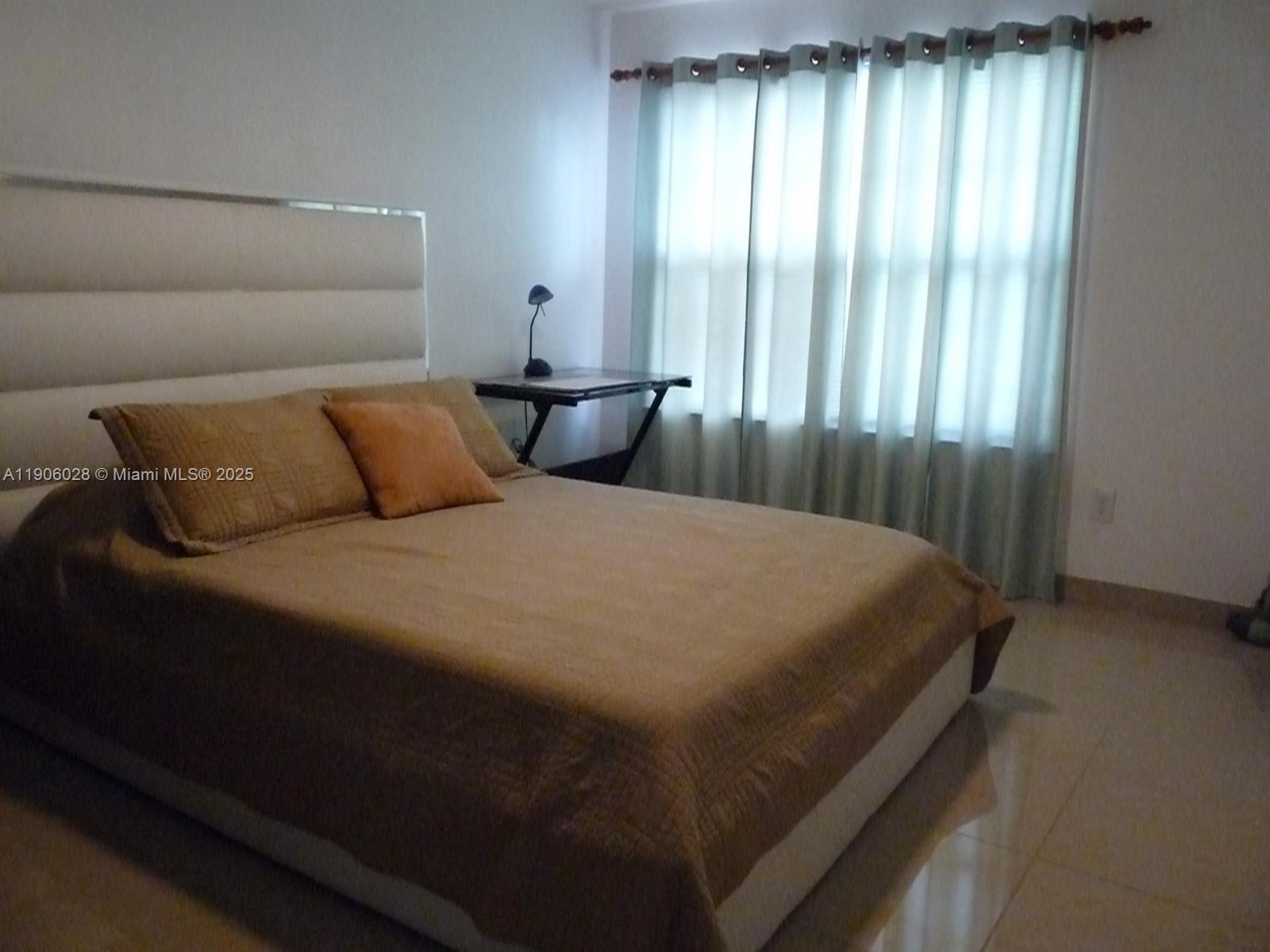 400 Summit Ridge Place, Unit 216 Longwood, FL 32779 - Photo 16 of 25 a bed sitting in a bedroom next to a window