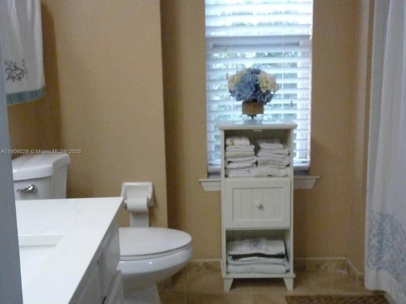 400 Summit Ridge Place, Unit 216 Longwood, FL 32779 - Photo 17 of 25 a bathroom with a toilet a sink and mirror