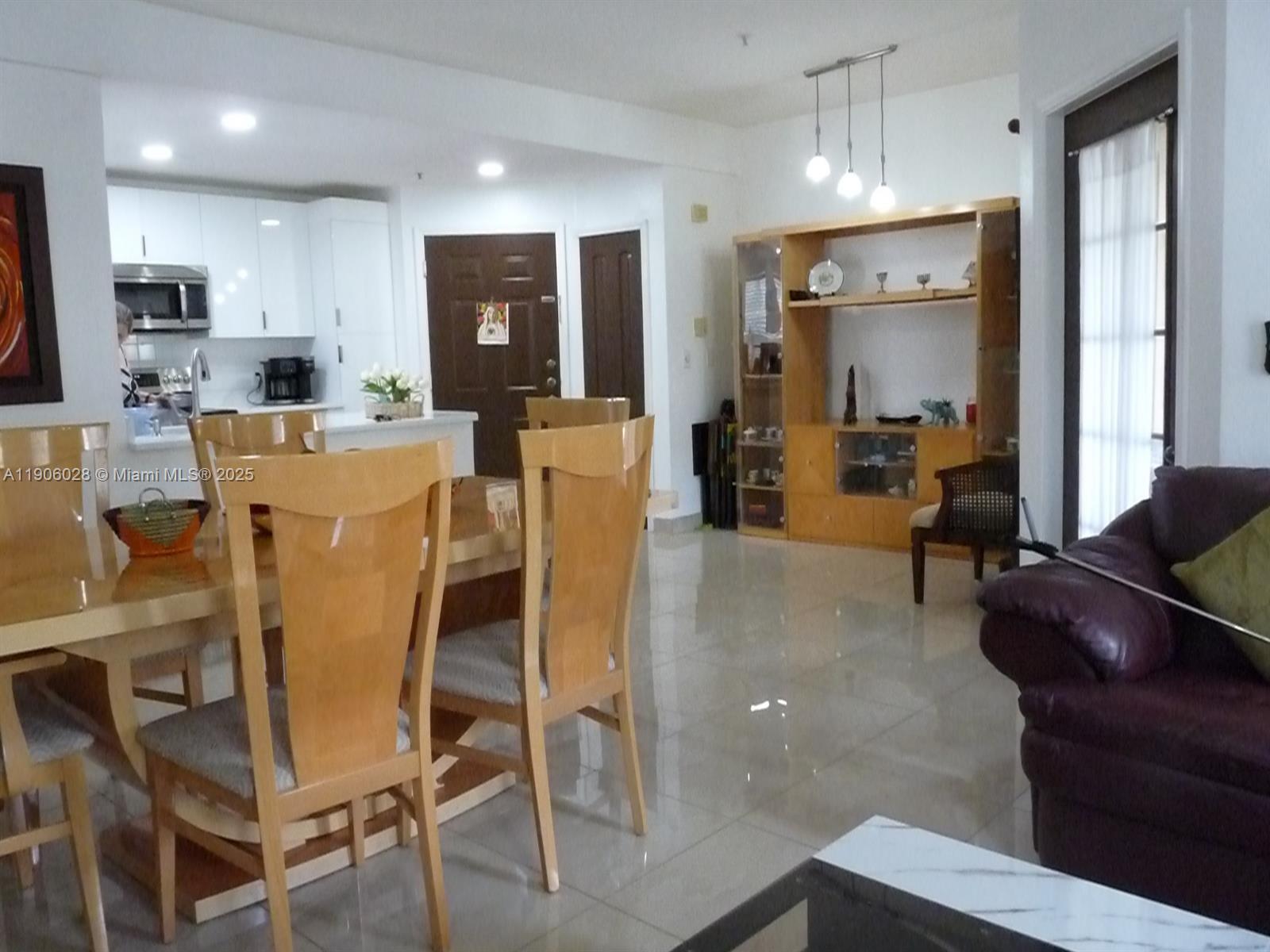 400 Summit Ridge Place, Unit 216 Longwood, FL 32779 - Photo 20 of 25 a living room with stainless steel appliances kitchen island granite countertop furniture and a view of kitchen