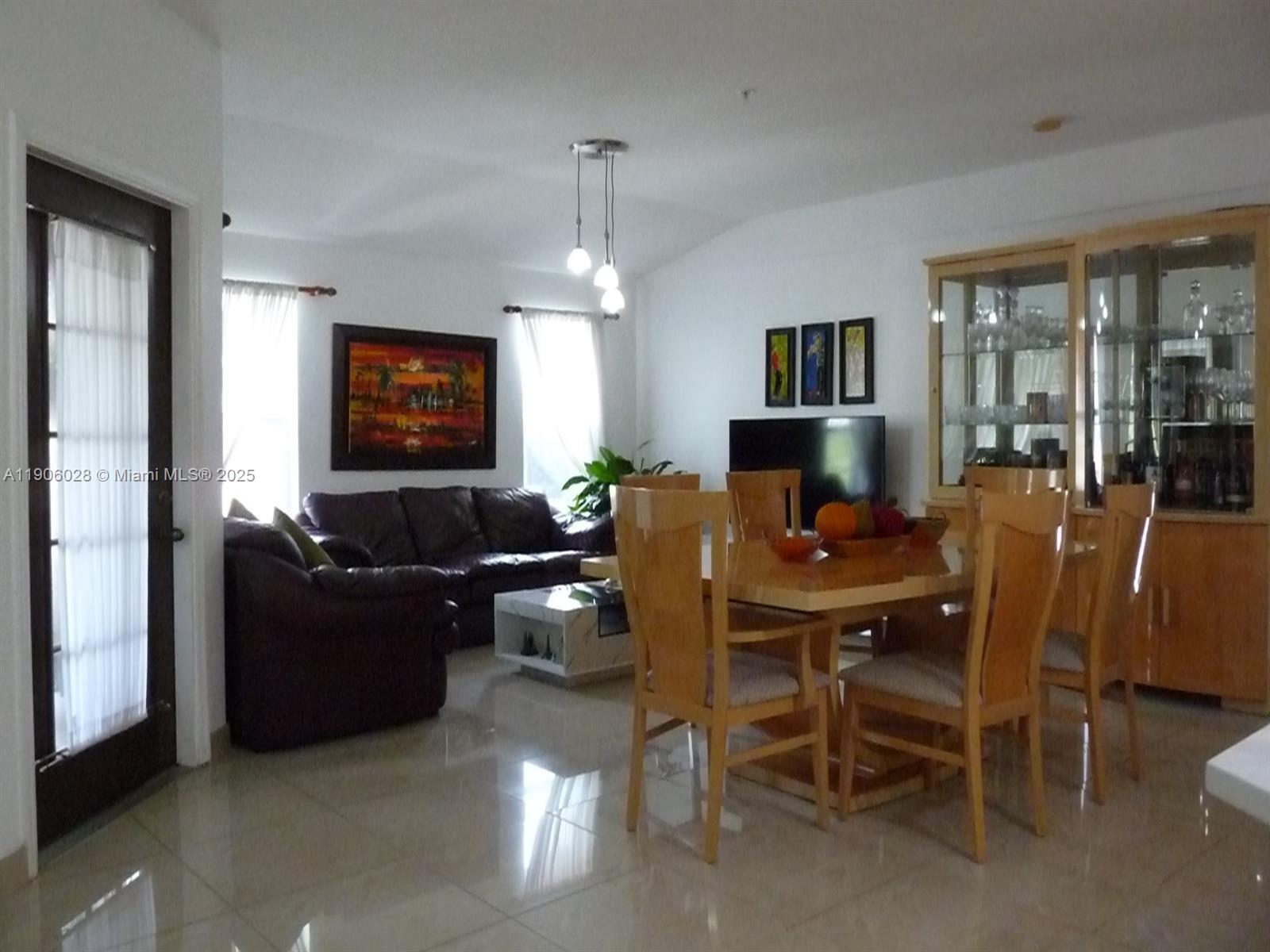 400 Summit Ridge Place, Unit 216 Longwood, FL 32779 - Photo 22 of 25 a living room with furniture and a flat screen tv