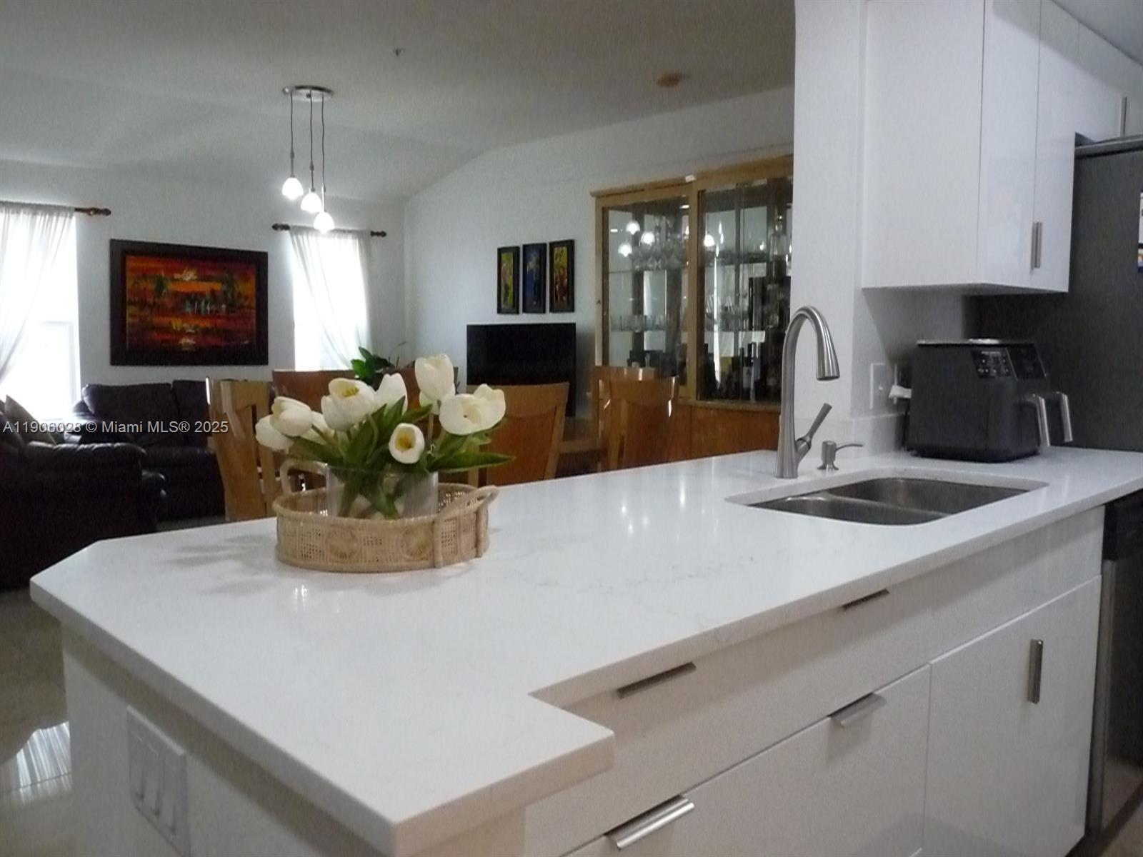 400 Summit Ridge Place, Unit 216 Longwood, FL 32779 - Photo 3 of 25 a kitchen with a sink a counter top space cabinets and appliances