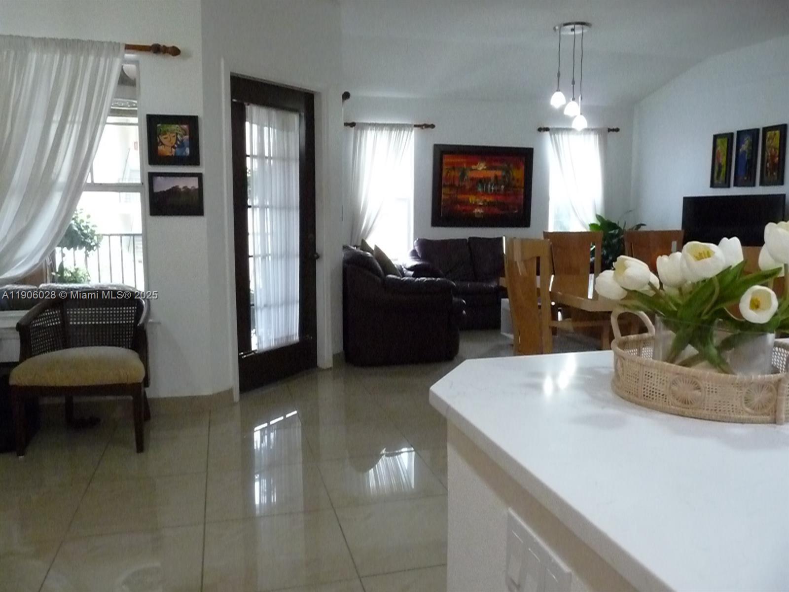 400 Summit Ridge Place, Unit 216 Longwood, FL 32779 - Photo 8 of 25 a living room with furniture and a flat screen tv