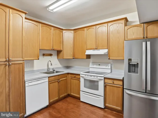 a kitchen with appliances cabinets and a sink