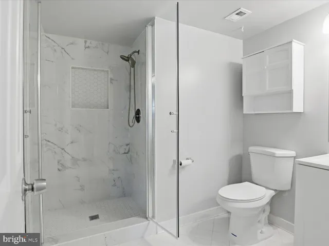 a bathroom with a toilet sink and shower