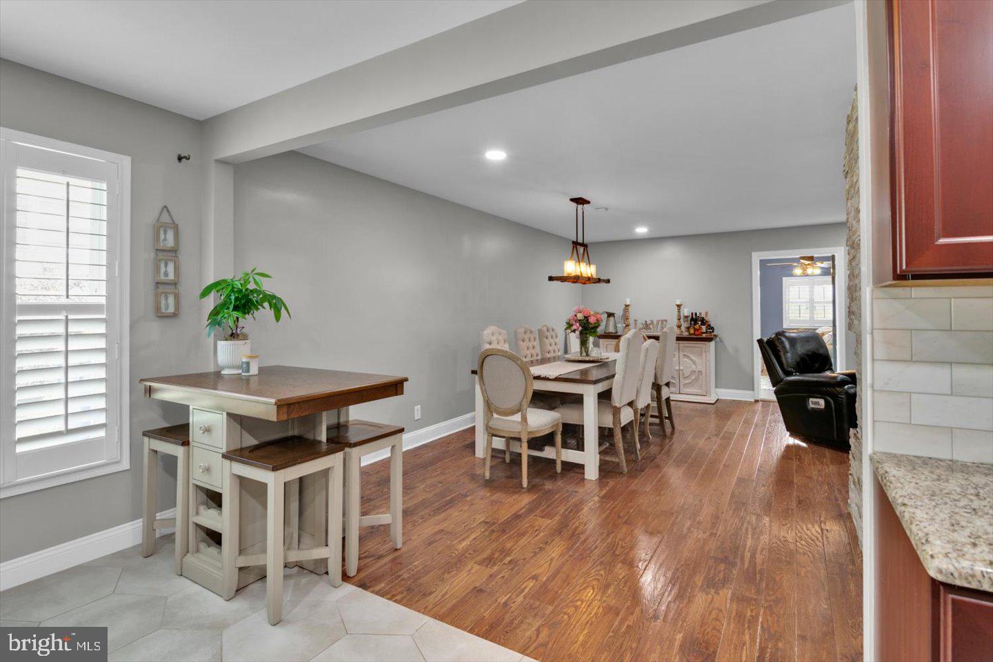 1102 Cooperskill Road Cherry Hill, NJ 08034 - Photo 11 of 38 a dining room with furniture a rug and wooden floor