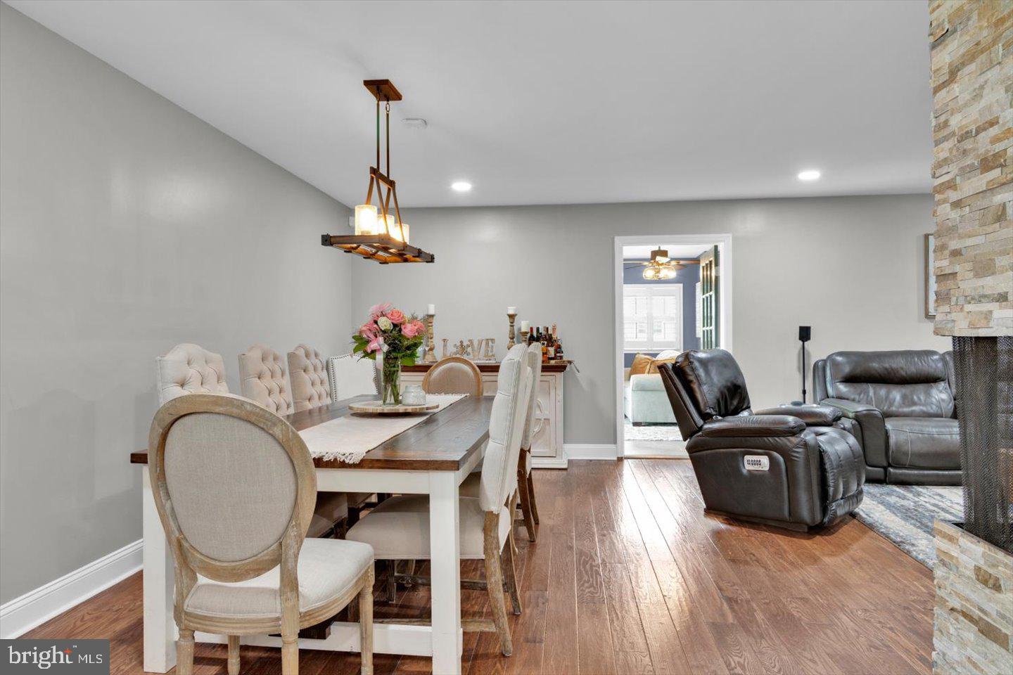1102 Cooperskill Road Cherry Hill, NJ 08034 - Photo 12 of 38 a dining room with furniture a chandelier and wooden floor