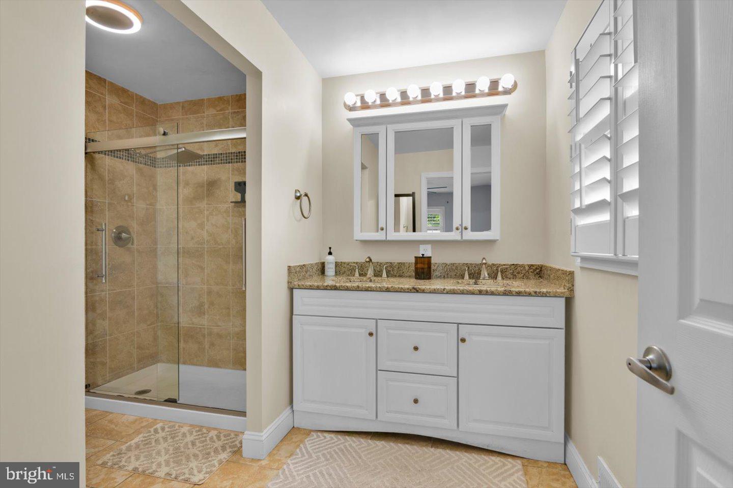 1102 Cooperskill Road Cherry Hill, NJ 08034 - Photo 23 of 38 a bathroom with a granite countertop sink a mirror and a shower