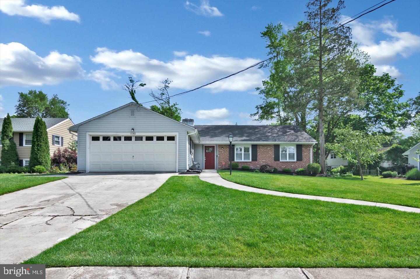 1102 Cooperskill Road Cherry Hill, NJ 08034 - Photo 33 of 38 a front view of a house with a yard and garage
