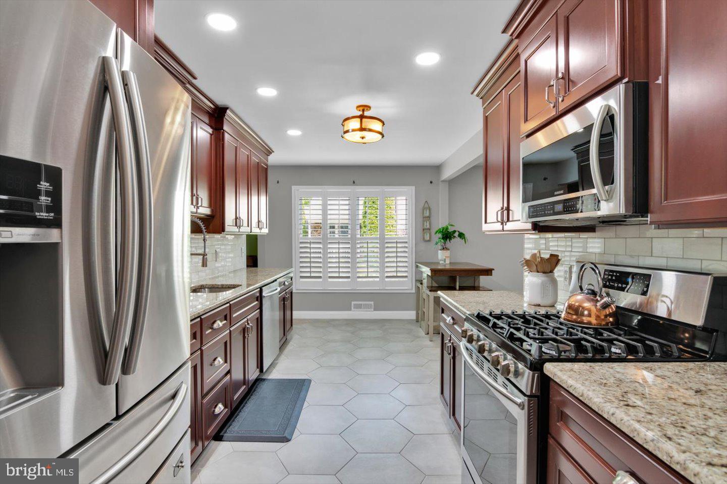 1102 Cooperskill Road Cherry Hill, NJ 08034 - Photo 5 of 38 a kitchen with stainless steel appliances granite countertop a stove a refrigerator and a sink