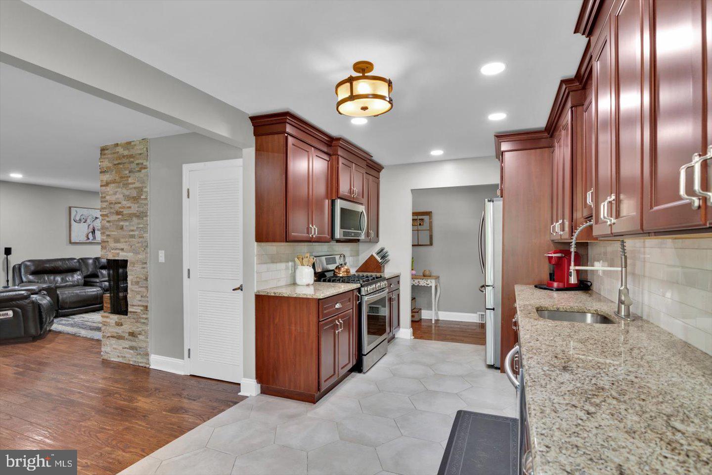 1102 Cooperskill Road Cherry Hill, NJ 08034 - Photo 9 of 38 a kitchen with stainless steel appliances granite countertop a stove refrigerator and cabinets