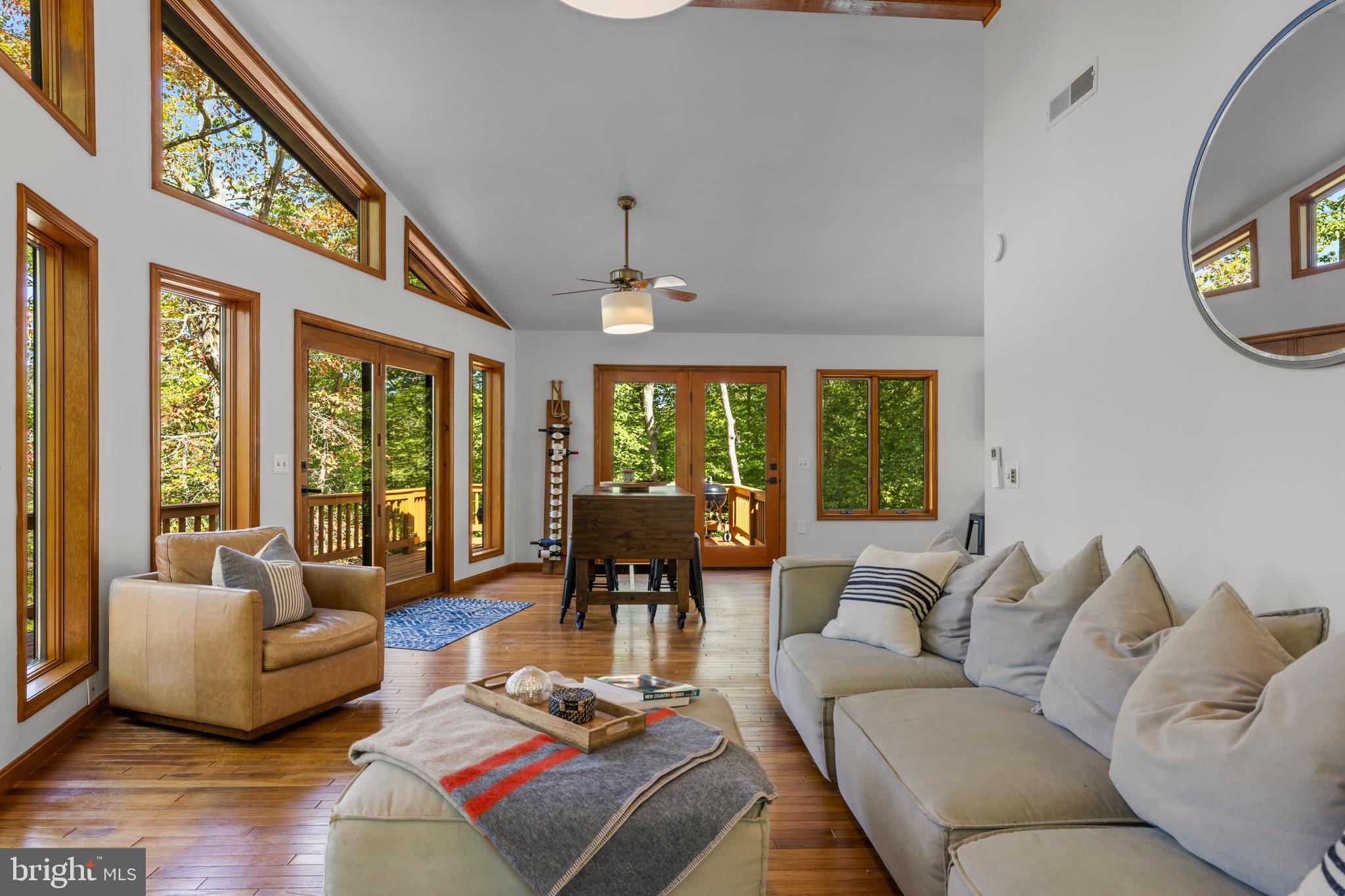 10050 Forrest Lane Chestertown, MD 21620 - Photo 12 of 49 a living room with furniture fireplace and large windows