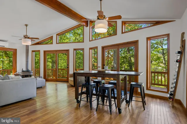 a view of a dining room with furniture window and wooden floor