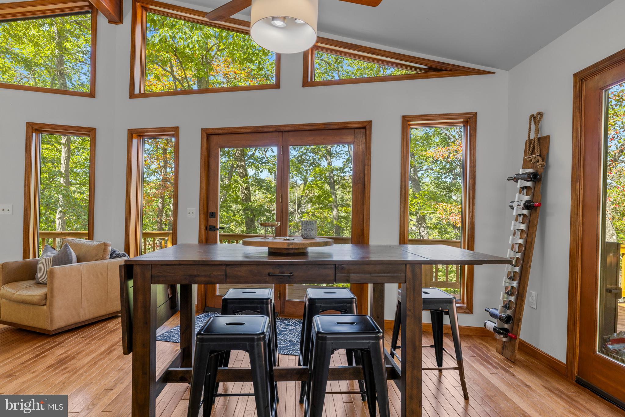 10050 Forrest Lane Chestertown, MD 21620 - Photo 14 of 49 a view of a dining room with furniture large windows and wooden floor