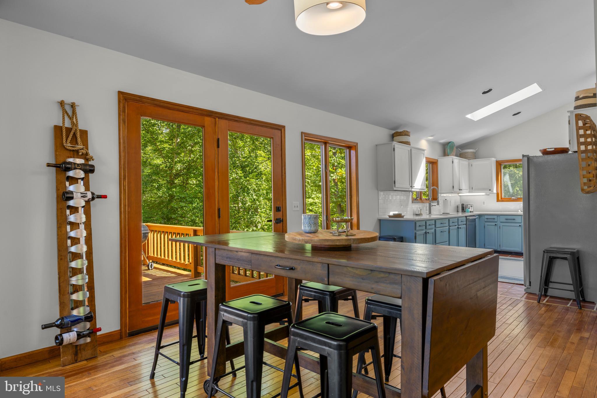 10050 Forrest Lane Chestertown, MD 21620 - Photo 15 of 49 a kitchen with stainless steel appliances granite countertop a table chairs refrigerator and sink