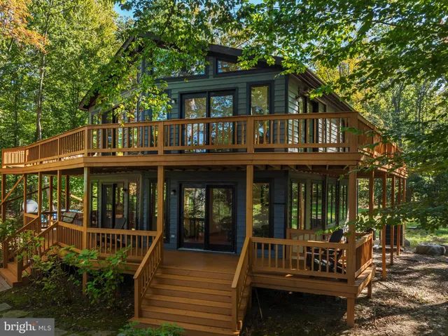 a view of house with a deck and furniture