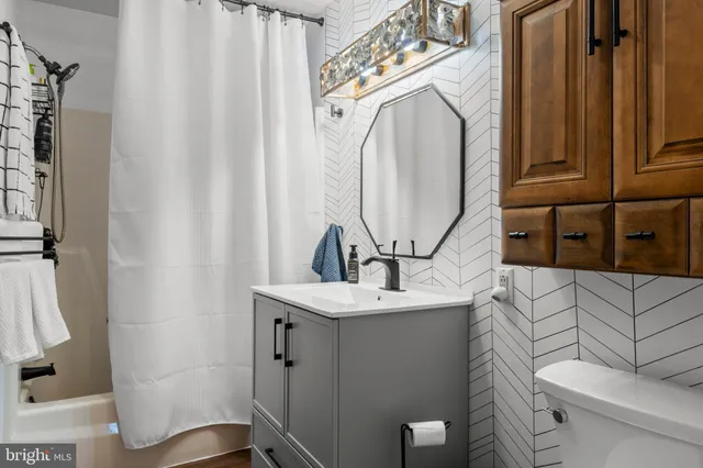a bathroom with a sink a toilet and mirror