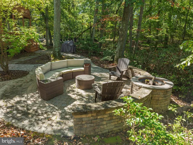 a view of a backyard with sitting area and garden