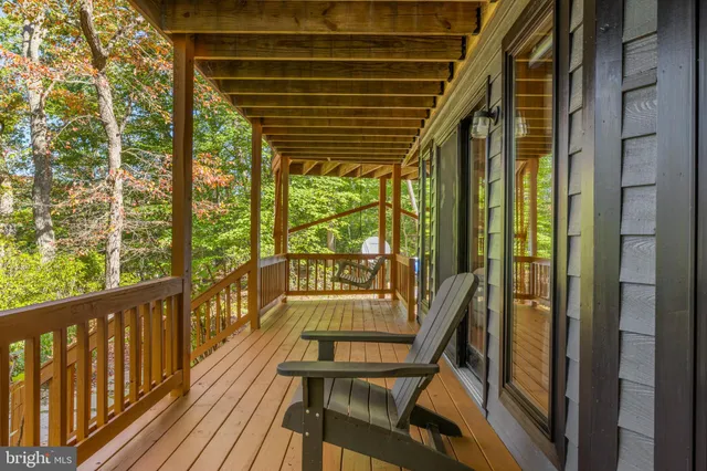 a view of a porch with wooden floor and outdoor seating