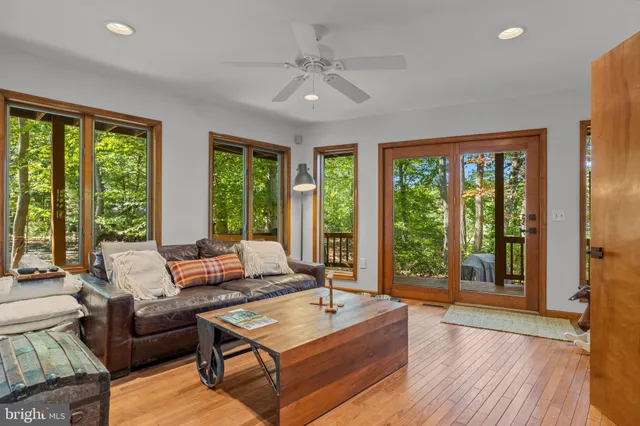 a living room with furniture and large windows