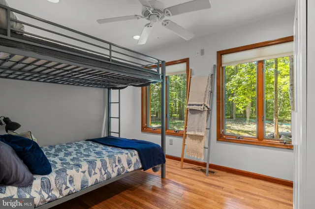 a bedroom with a bed and a large window