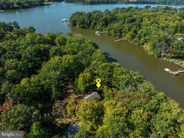 an aerial view of a houses with a lake view