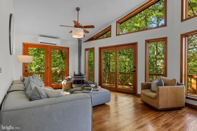 a living room with furniture and floor to ceiling windows