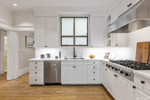 a view of a dining room with furniture wooden floor and a chandelier