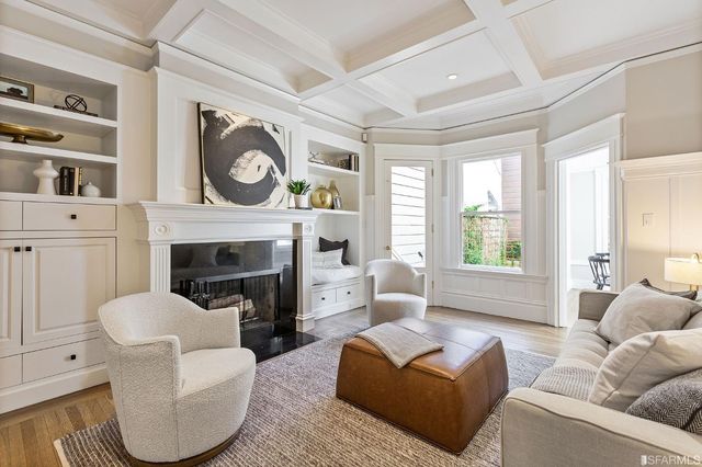 a view of a hallway with wooden floor and entryway
