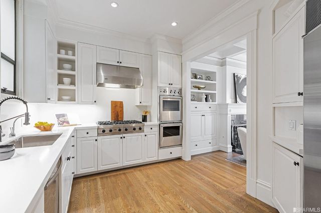 a view of a dining room with furniture large windows and wooden floor