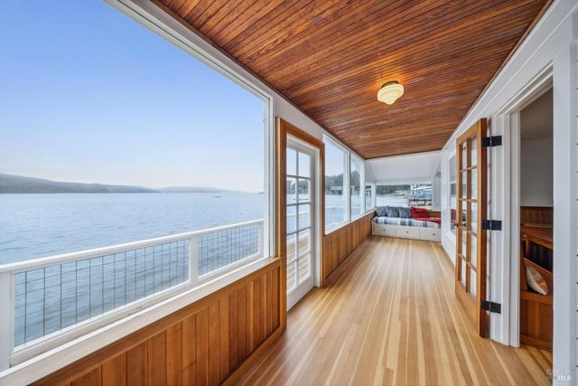 a view of a balcony with wooden floor
