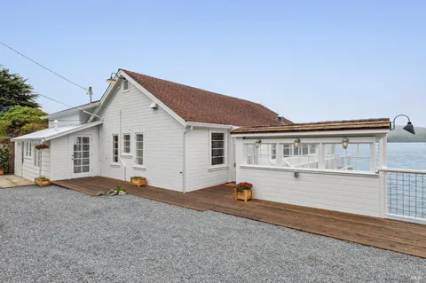 a view of house with backyard and deck