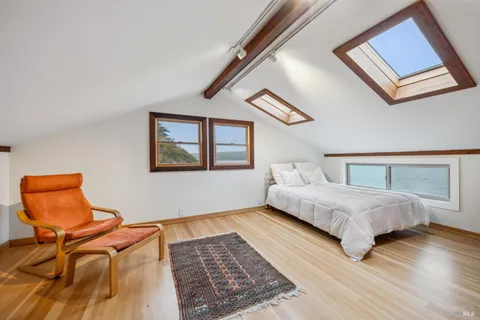 a bedroom with a bed and chair