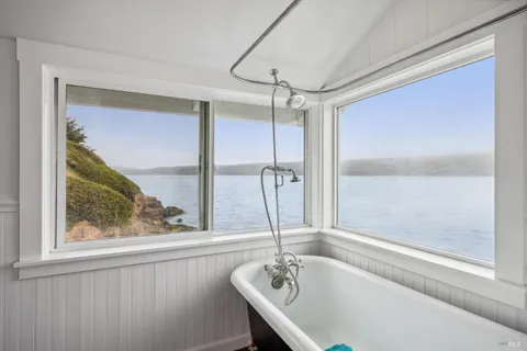 a bathroom with a tub and a shower