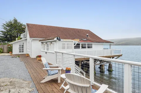 a balcony with table and chairs