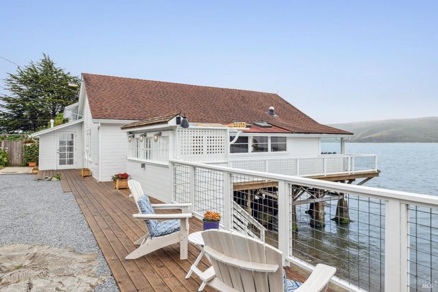a balcony with table and chairs