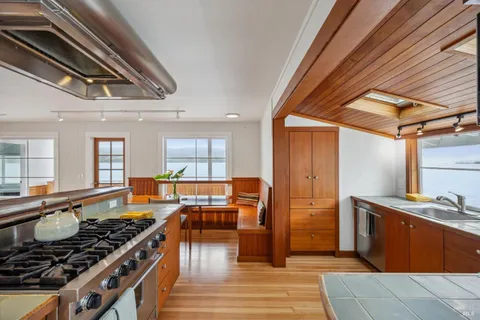 a kitchen with stainless steel appliances granite countertop a stove and a sink