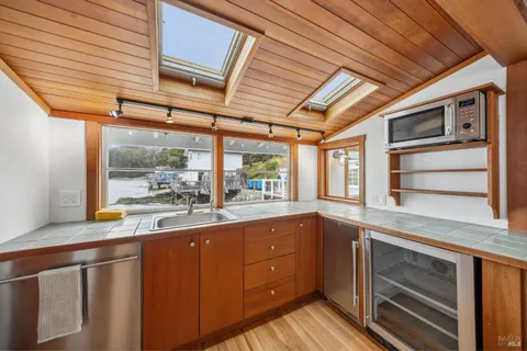 a kitchen with a sink and large window