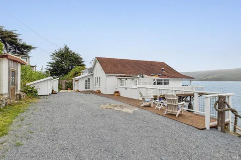 a view of a house with backyard and sitting area