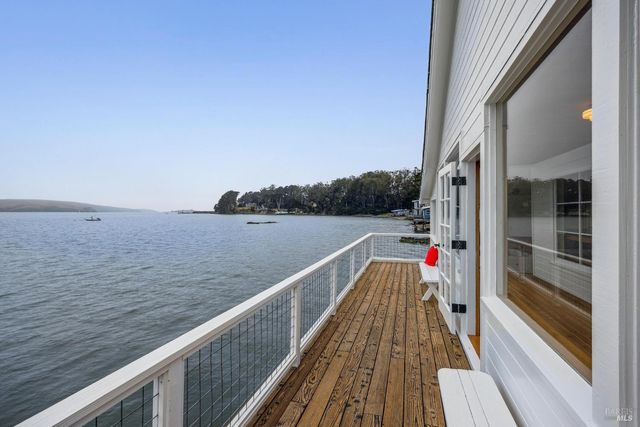 a view of balcony with wooden floor and fence